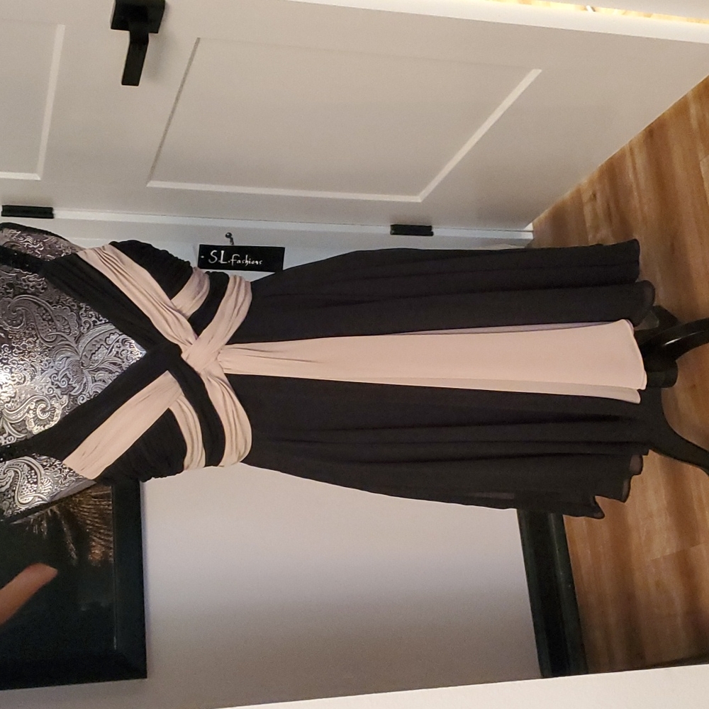 Evening Dress! Never Worn still has tags. Black and Tan with a flaired bottom.